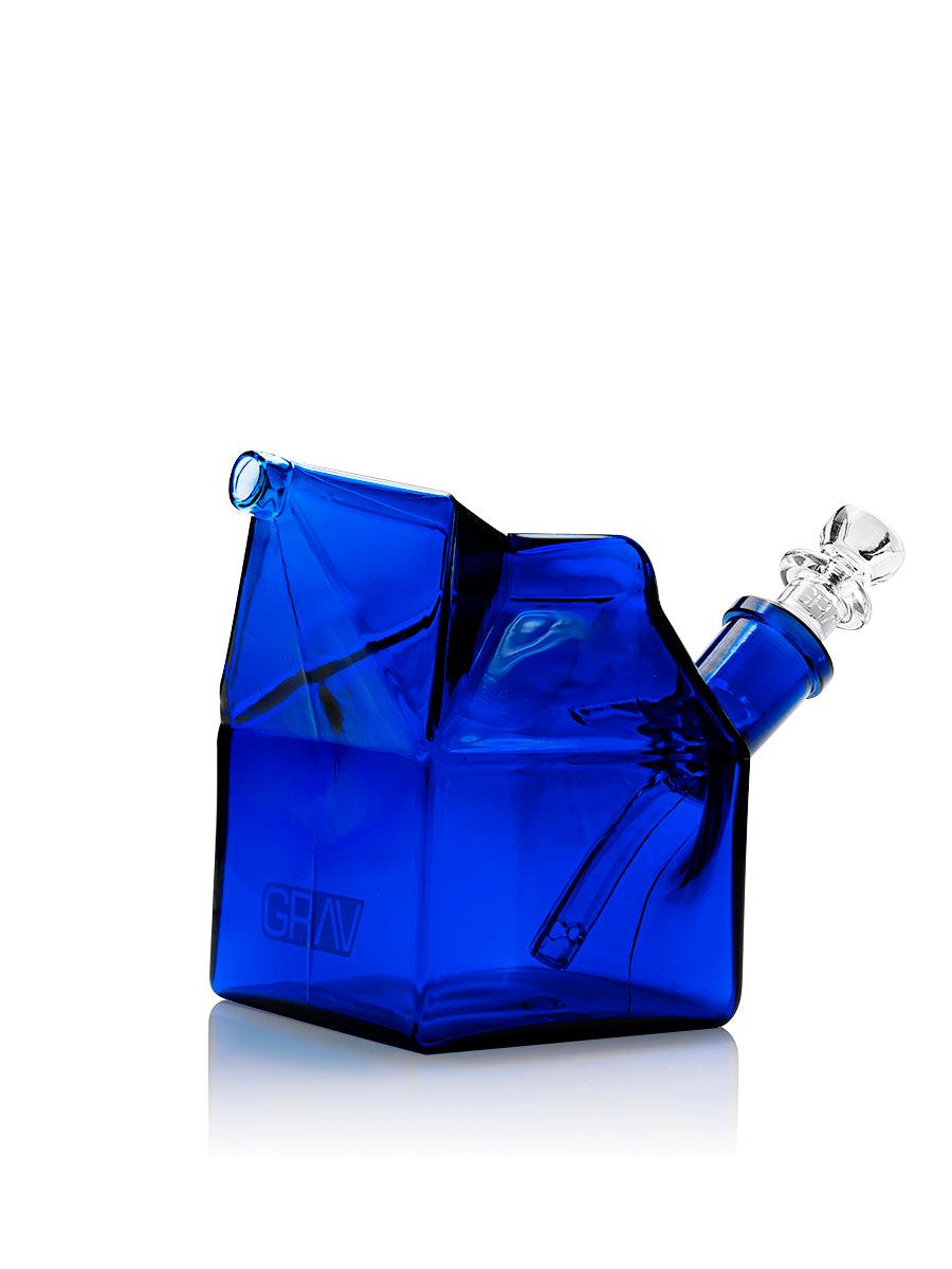 GRAV Milk Carton bubbler in assorted colors with a cobalt blue finish, featuring a playful, cartoon-style design for smoking accessories.