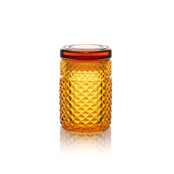 Amber glass jar from Jane West's Twenties Collection, styled as a chic accessory with a vintage-inspired design.