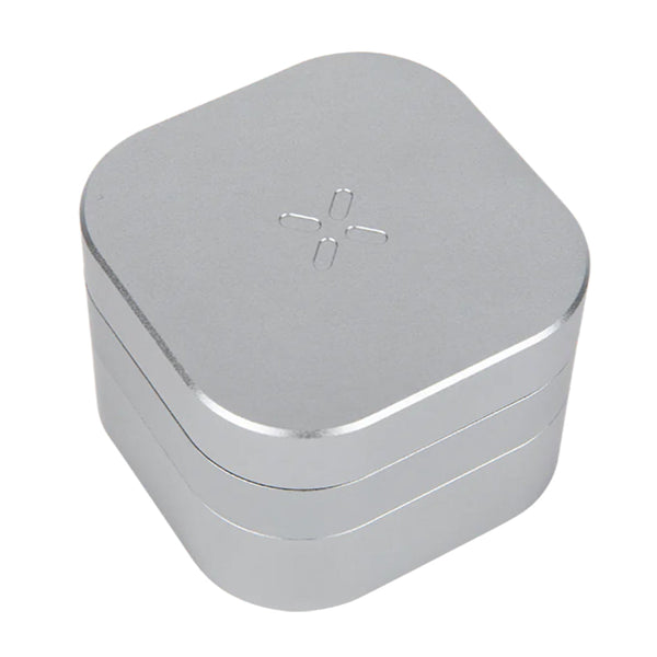 Pax Grinder with metallic finish and textured grip, showing the cylindrical shape and grinding mechanism for herb processing.