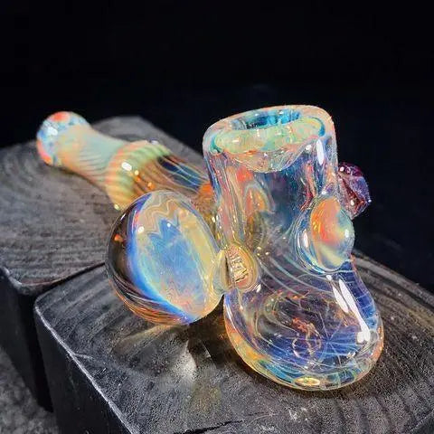 Ease Glass Fume Hammer glass pipe with a clear body and artistic fume design, featuring a bowl and mouthpiece for smoking.