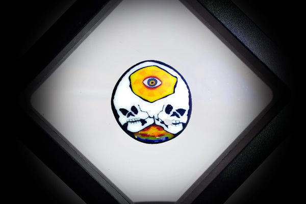 East Atlanta S&V AKM Glass Pipe Maker third eye skull millie, colorful glass art with detailed skull design on transparent background.