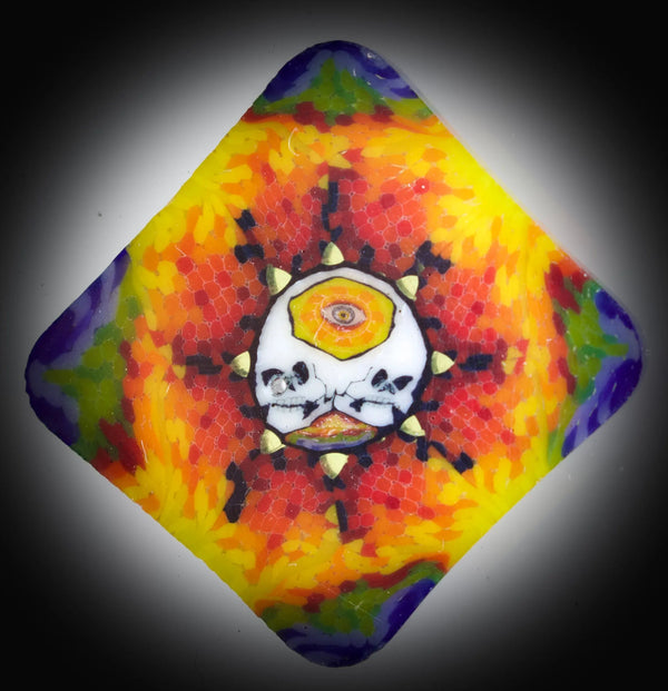 East Atlanta S&V AKM Glass Pipe Maker with tie-dye skull design, featuring colorful glass art and intricate millie details.