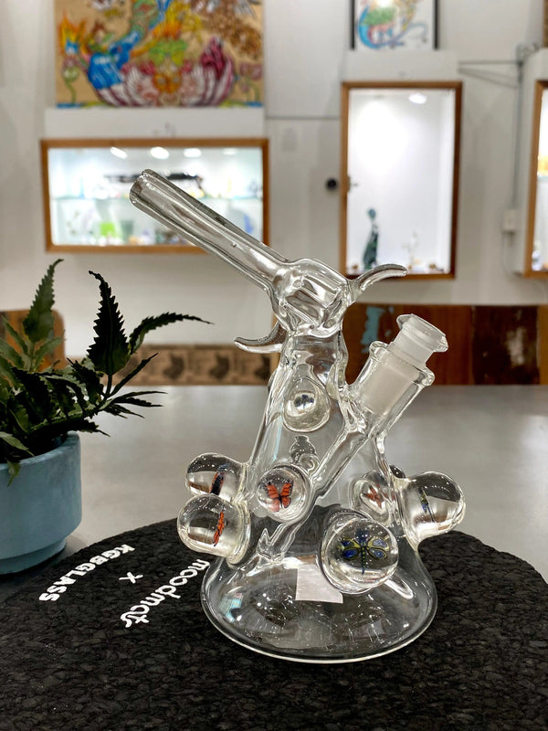 Piece Maker Glass revolver rig, a clear glass pipe with colorful accents, designed for dabbing and concentrates.