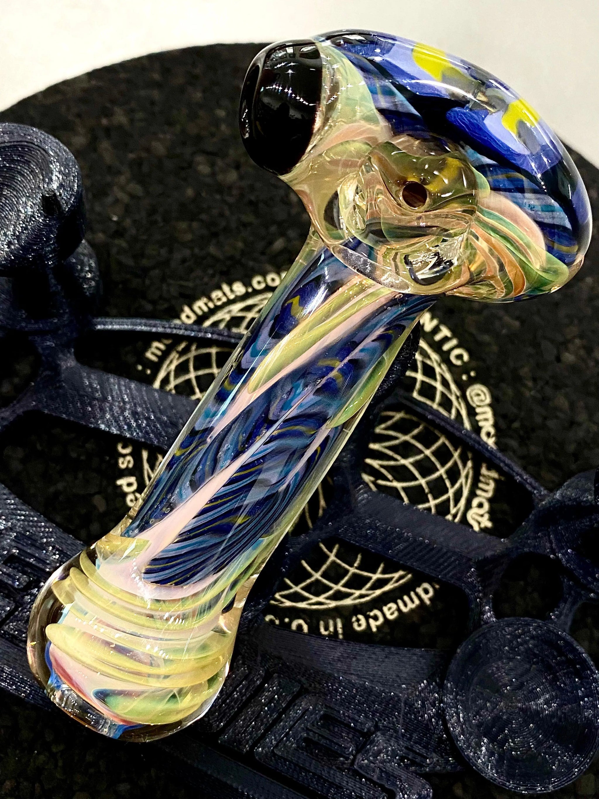 Colorful flower-shaped glass pipe by Talent Glass Works Inc, featuring intricate glass craftsmanship and vibrant floral design.