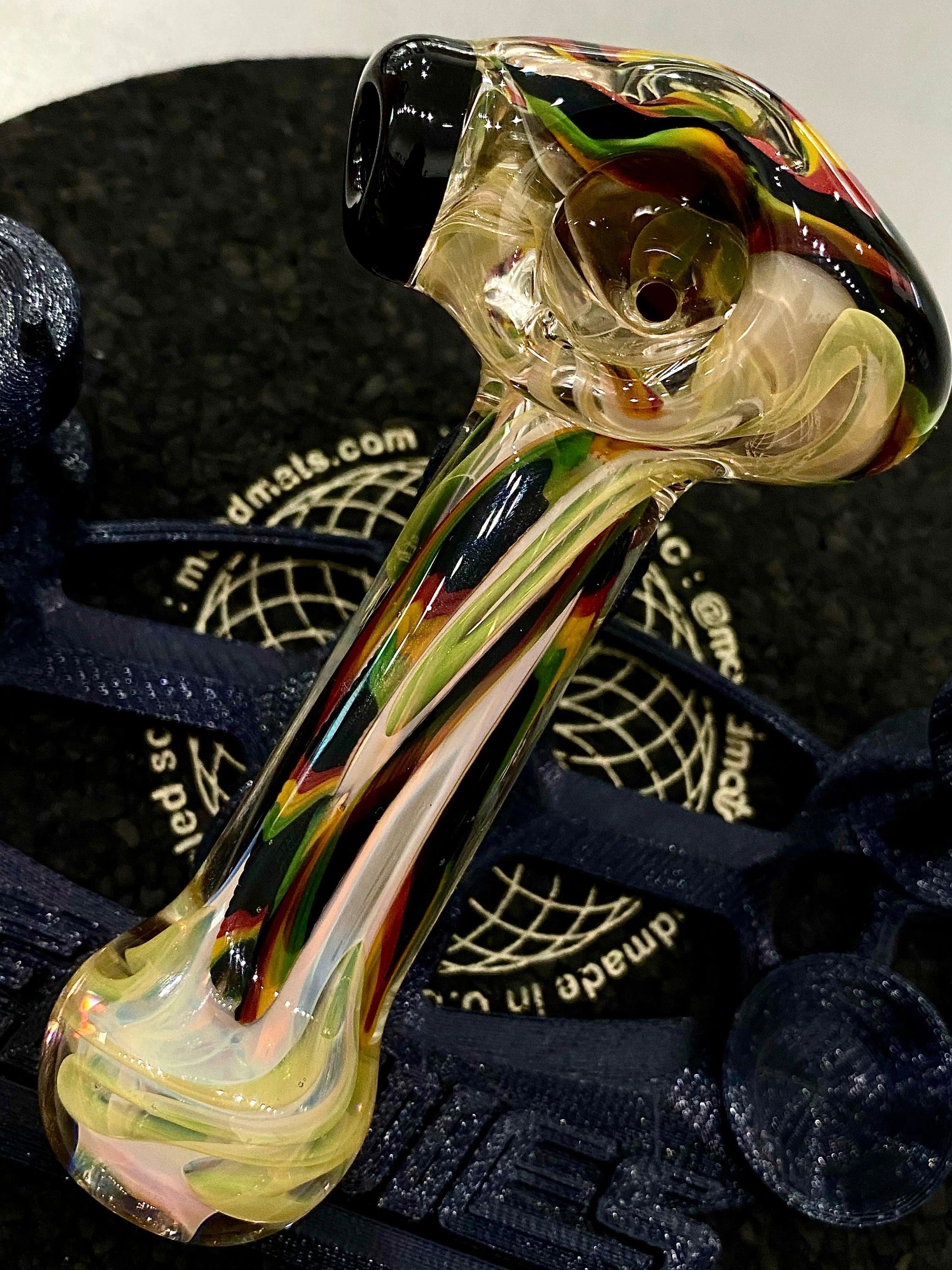 Colorful flower-patterned glass spoon pipe by Talent Glass Works Inc, showcasing vibrant design and clear glass construction.
